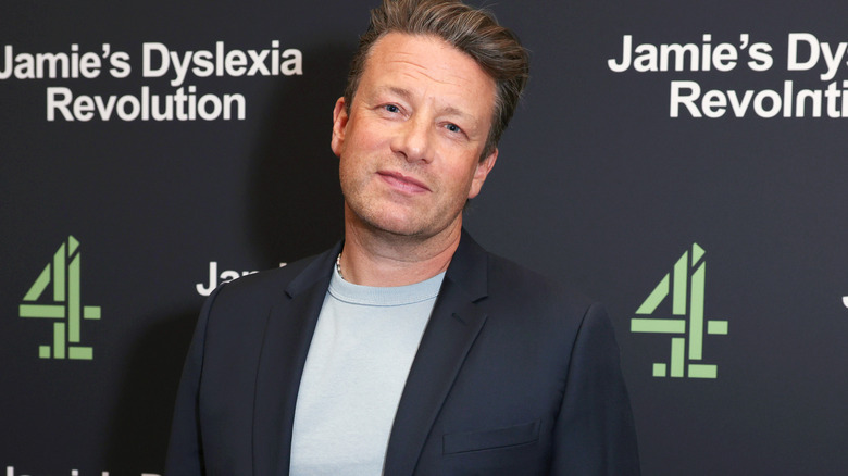Chef Jamie Oliver posing on a red carpet