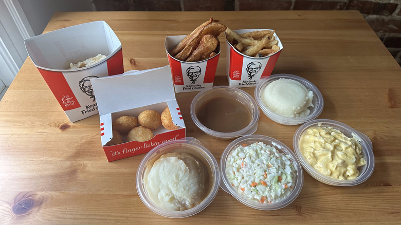 Various KFC side dishes on wooden table