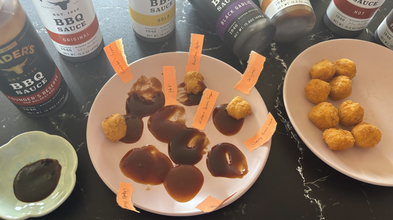 Various BBQ sauce bottles, sauces with name labels on plate, and chicken nuggets on plate