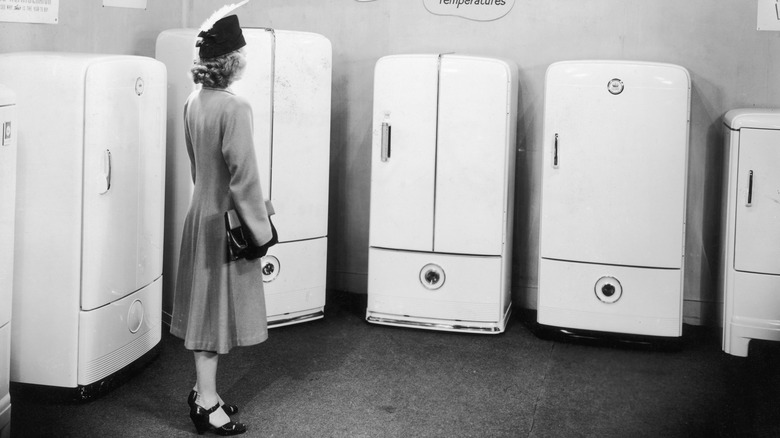 Woman looking at Frigidaire refrigerators in 1945