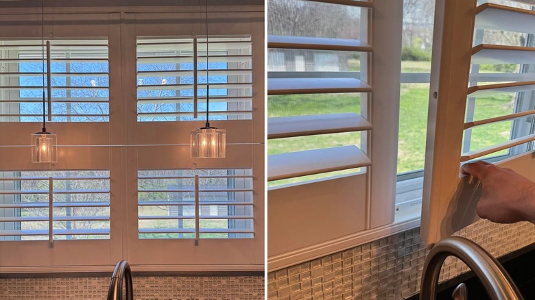 A kitchen window obstructed by a faucet and light fixtures