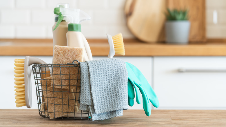 Basket of cleaning products on kitchen countertop