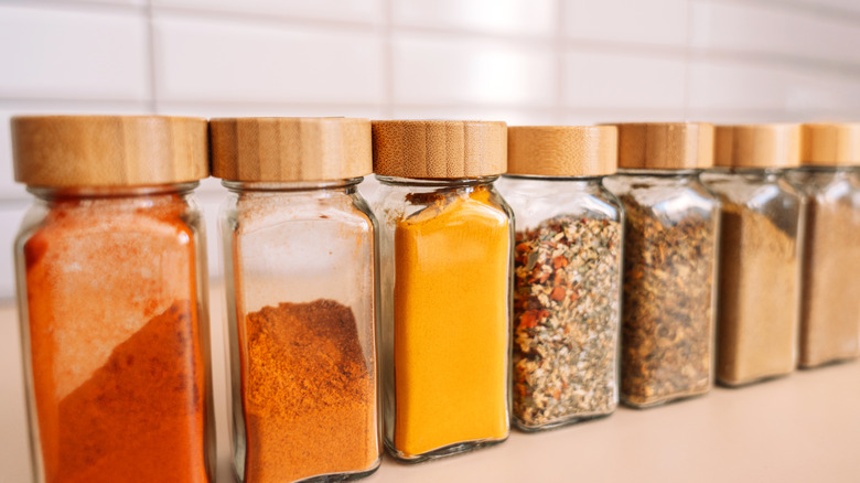 Spice jars lined up on kitchen countertop