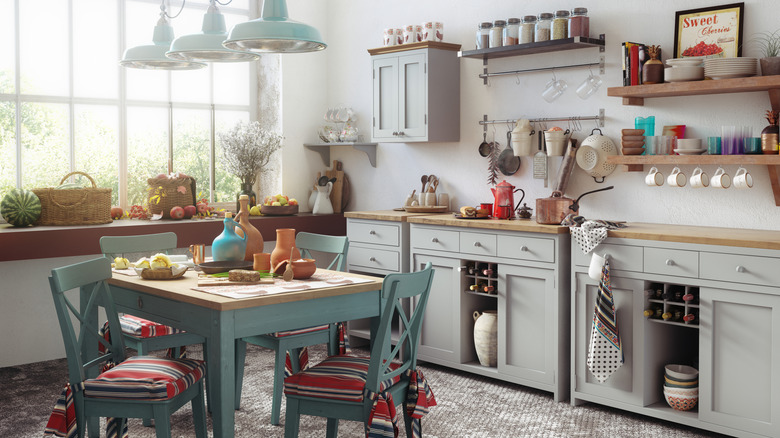 Rustic kitchen with square table and coordinated blue chairs for dining in