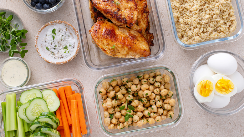 Glass containers with portioned food sitting in the prep area of the kitchen