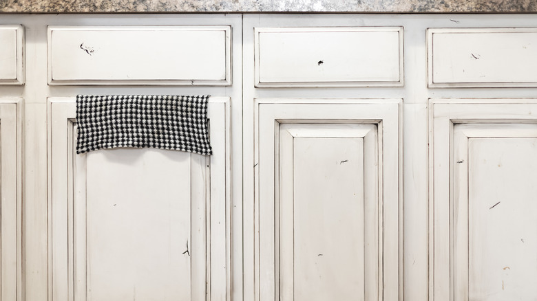 Lower row of kitchen cabinets made with distressed wood