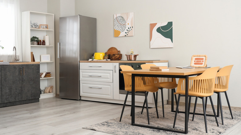 Kitchen interior with dining taable, fridge and counter