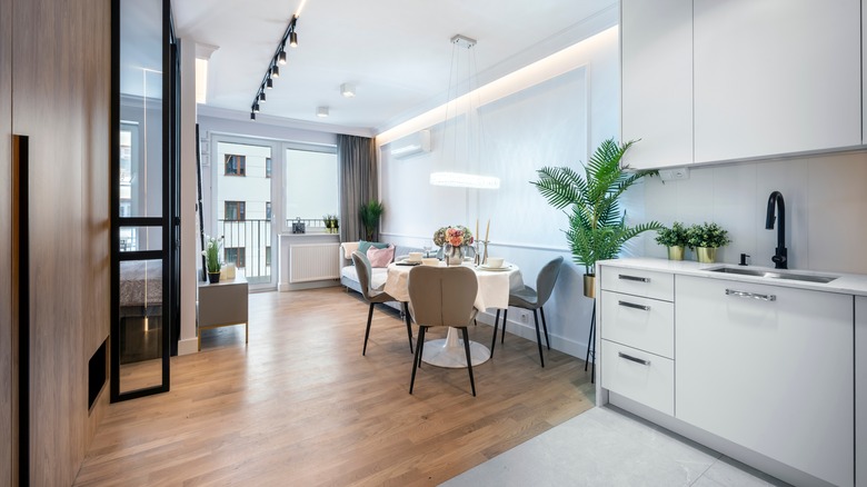 Open plan kitchen interiors featuring bright cabinetry and walls