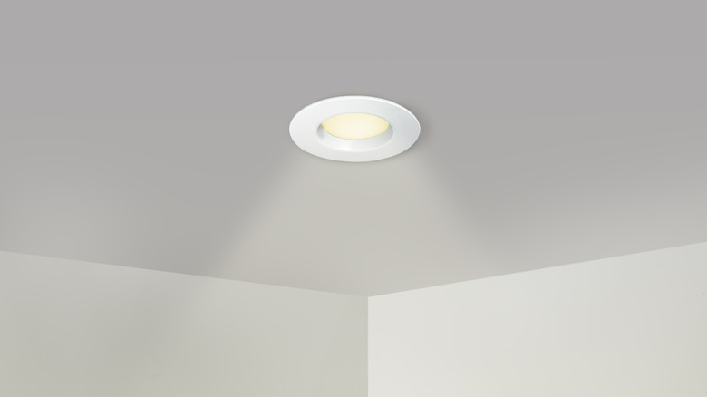 Spotlight Recessed lighting throwing illumination around a white room