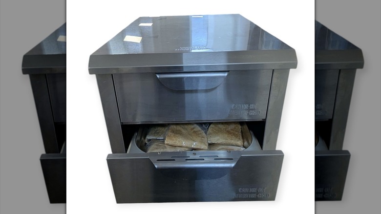 Isolated image of food warming in a drawer against a white background