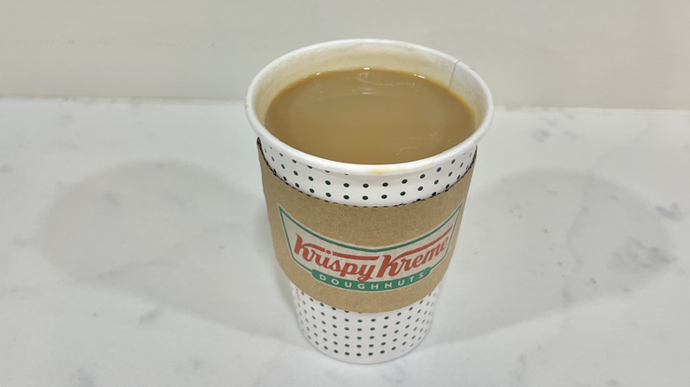 Krispy Kreme hot caramel specialty latte in to-go cup.