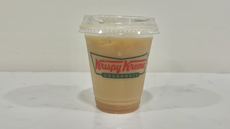 Krispy Kreme ice caramel coffee with milk in to-go cup.