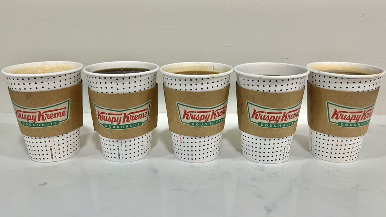 5 hot Krispy Kreme coffees in to-go cups.
