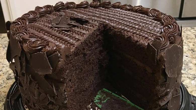 Large chocolate cake with slice cut out
