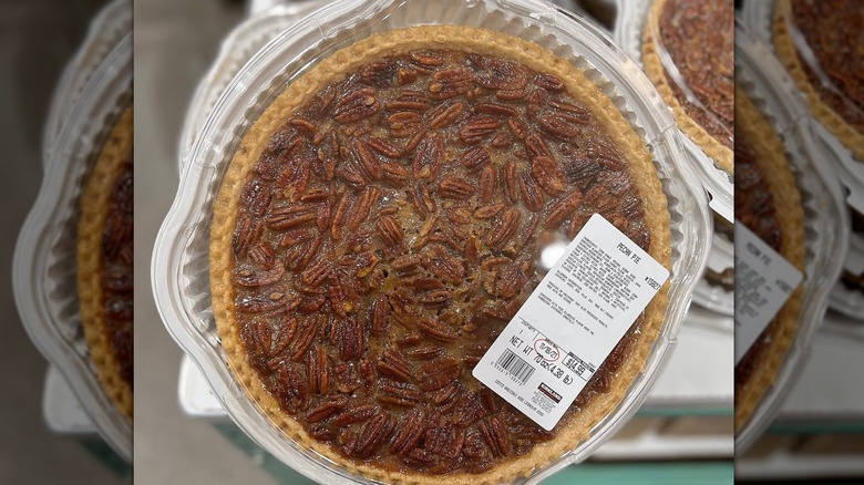 A Costco pecan pie in a white plastic dish