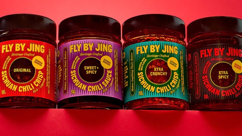 Four Fly By Jing chili crisps on red background