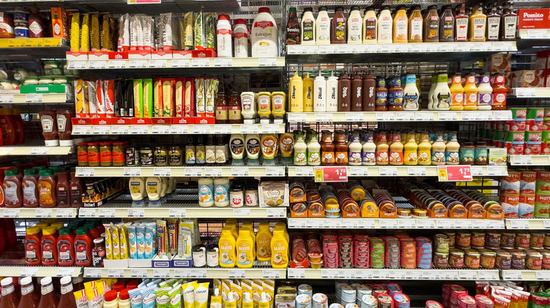 Rows of condiments on display in grocery store