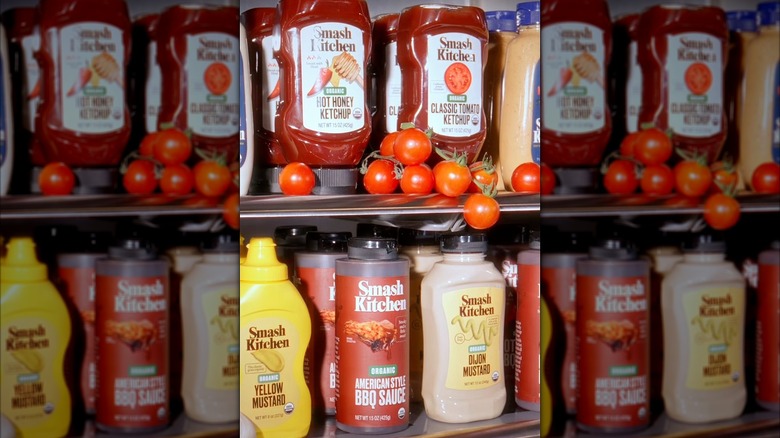 Fridge shelves with Smash Kitchen condiments and tomatoes