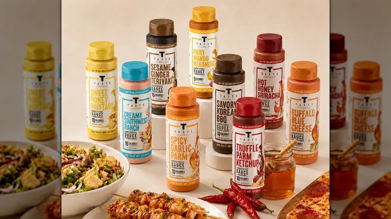 Sauces from Taste Flavor Co. on beige surface behind various dishes