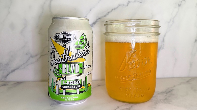 Can of Boulevard Brewing Southwest BLVD next to glass of beer on marble surface