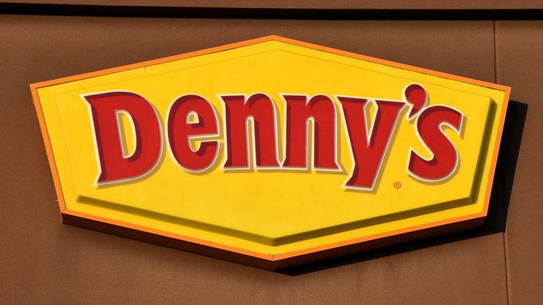 Sign for Denny's restaurant on brown wall