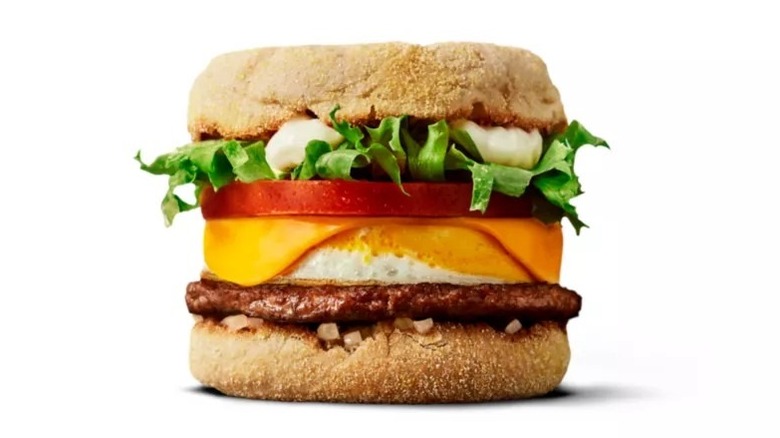 McDonald's McMuffin Deluxe with sausage, egg, cheese, tomato, and lettuce