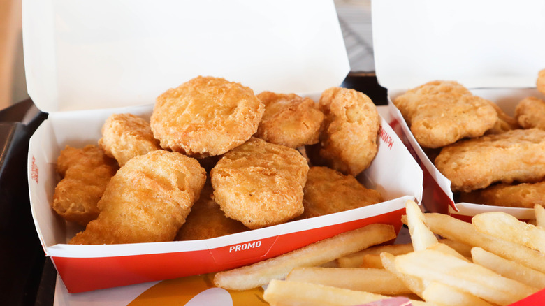 Two boxes of McDonald's Chicken McNuggets with fries