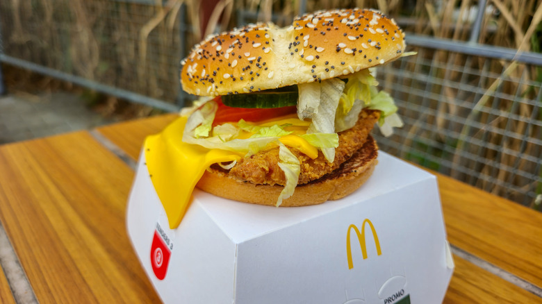 A McDonald's Deluxe McCrispy on top of its box on a table