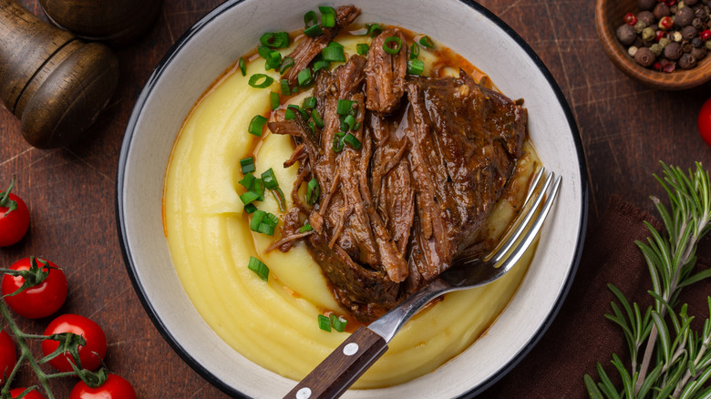 Roast Beef with mashed potatoes and gravy on table