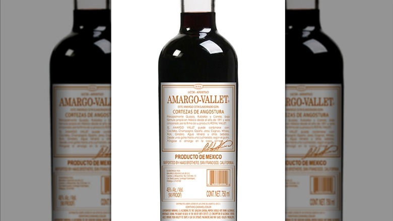 Mirrored image of Amargo-Vallet bottle against white background.