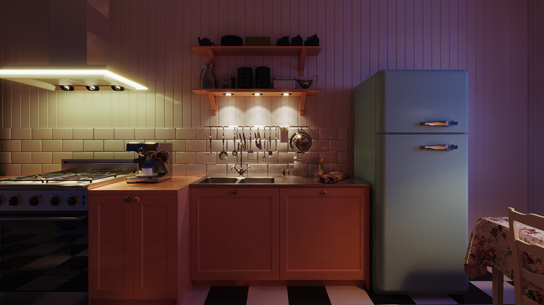 A kitchen with an illuminated range hood