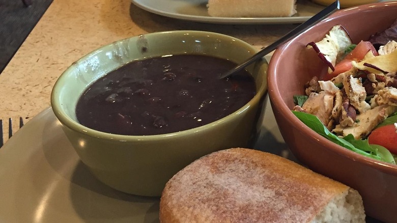 Bowl of black bean soup with a spoon