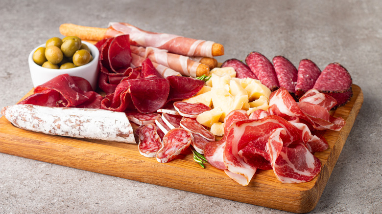Meat and cheese arranged on charcuterie board