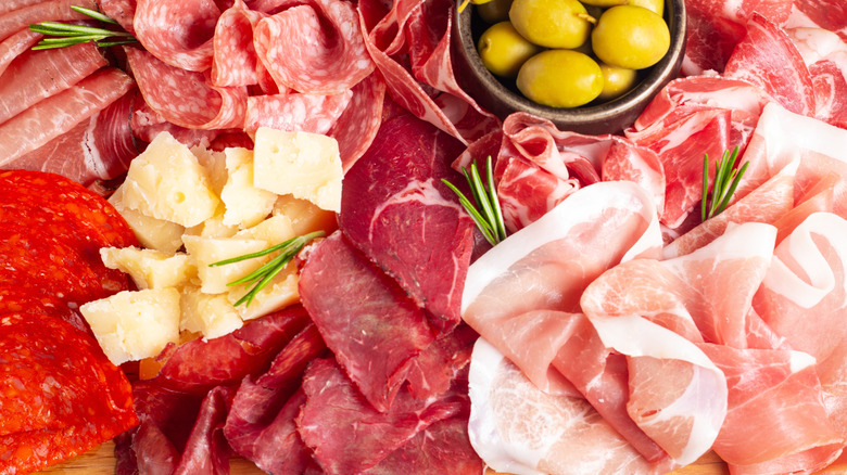 Folded and arranged deli meats on charcuterie board