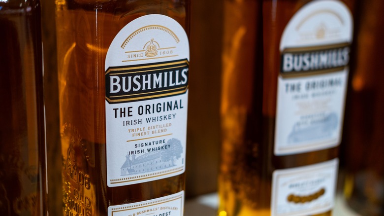 A close up of two bottles of Bushmills Irish Whiskey showcasing a different type of whiskey