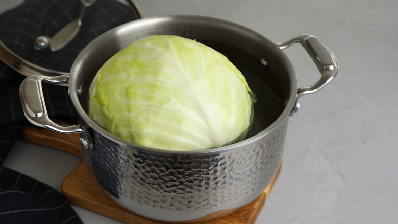 A whole head of cabbage in a metal pot