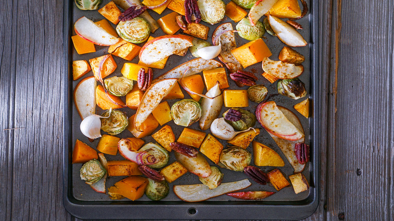 Roasted root vegetables crowded on baking sheet