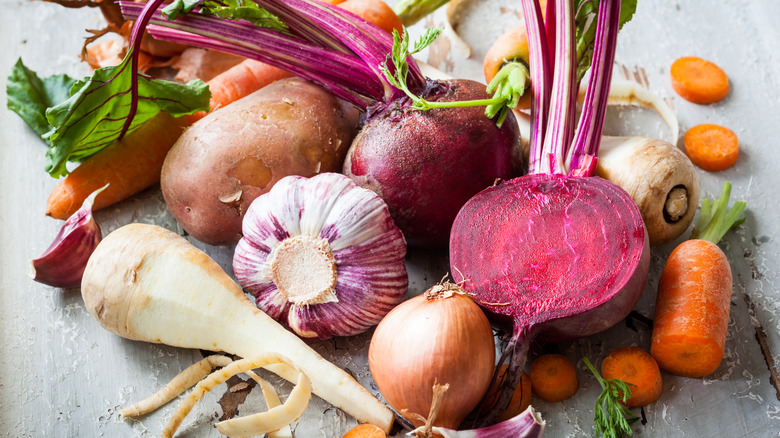 Various types of root vegetables on wooden table