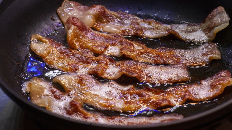 Bacon frying in cast iron pan