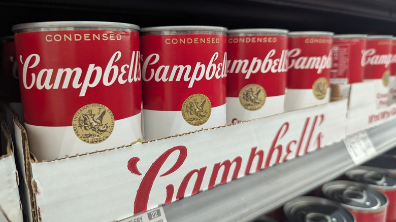 A grocery store shelf with Campbell's soup