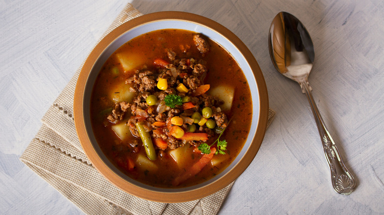Bowl of soup with ground beef and frozen mixed vegetables