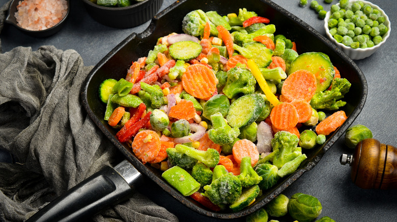 Mixed frozen vegetables in large square frying pan