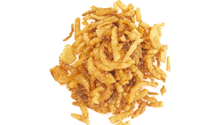 French fried onions in a pile on white background
