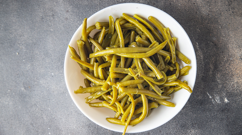 Canned green beans on white plate