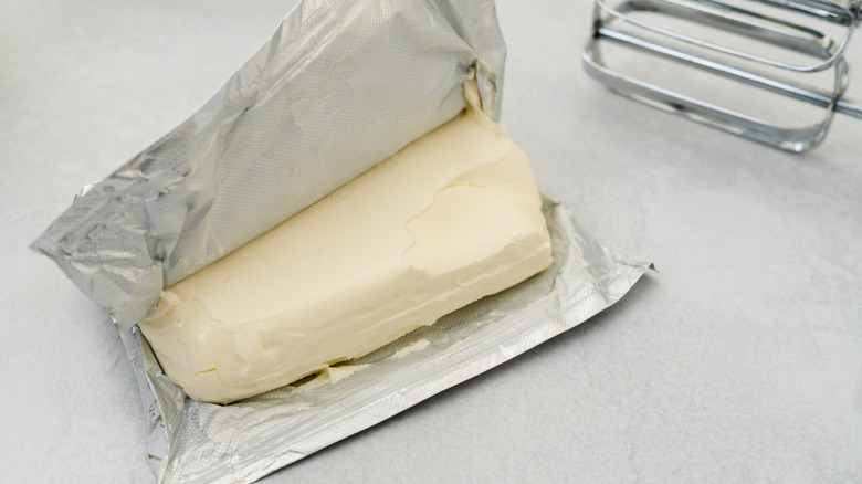 An opened block of cream cheese still in its wrapper