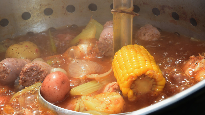 close up of ladle full of seafood boil