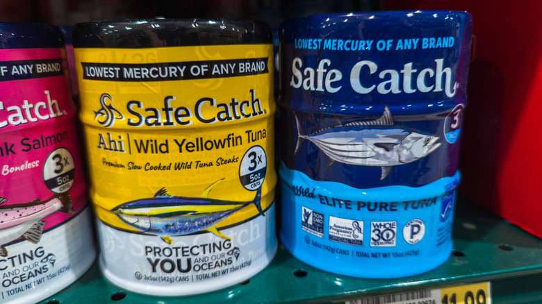 Cans of Safe Catch tuna on grocery store shelf