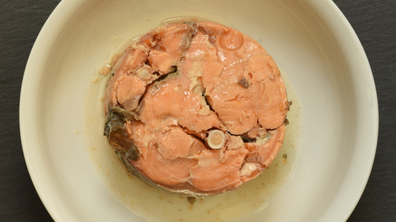 Canned salmon with visible bones in white bowl