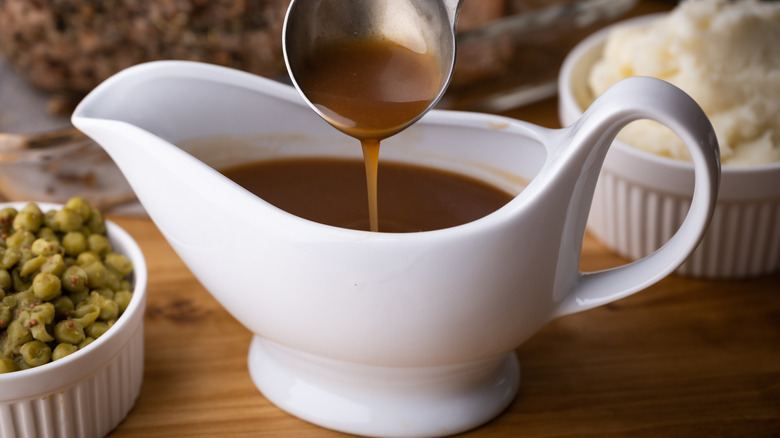 Brown gravy in a white gravy boat