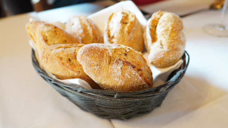 Basket of bread rolls on a table